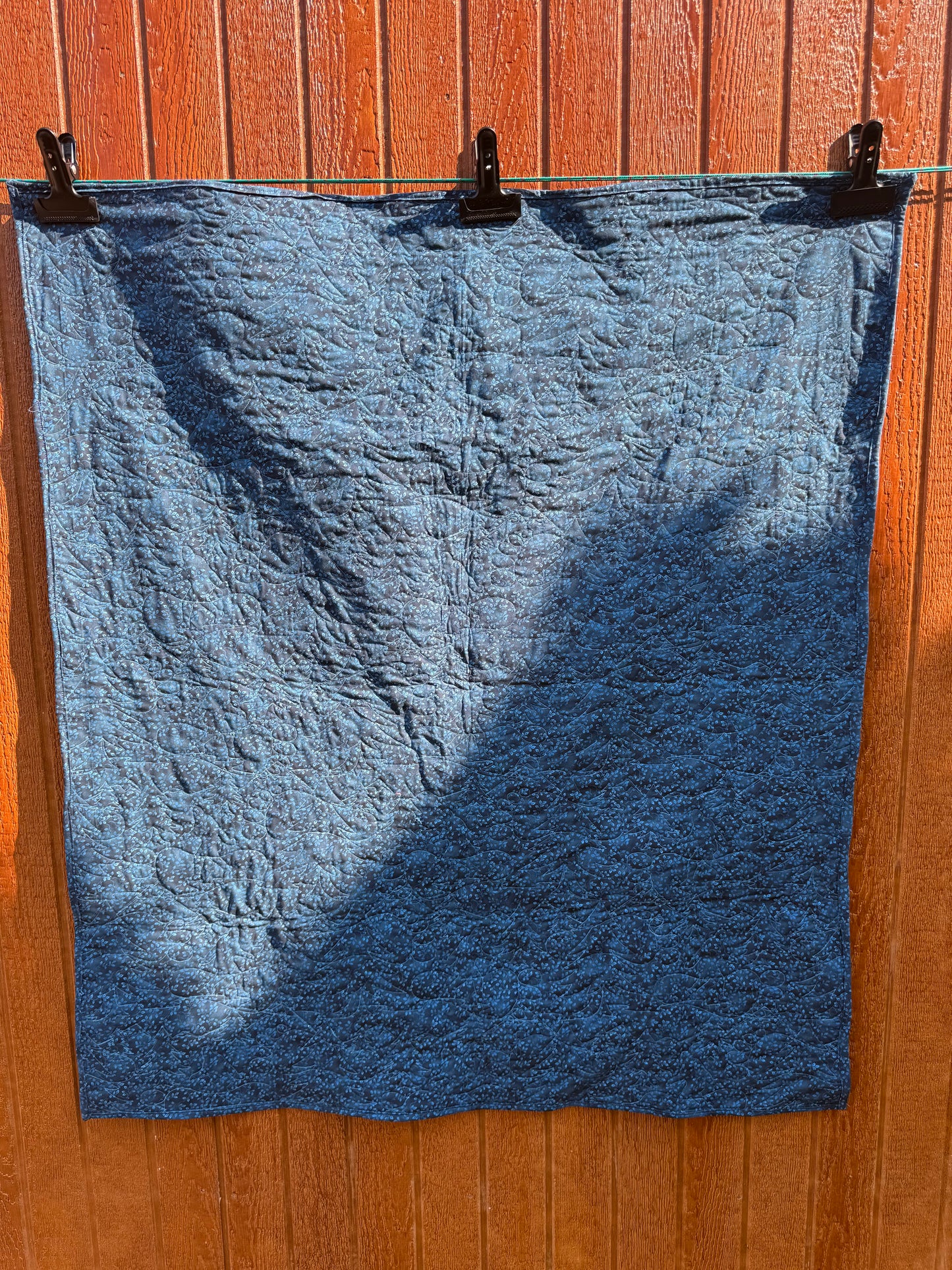 "Handmade quilt with traditional piecing and professional quilting finish"
