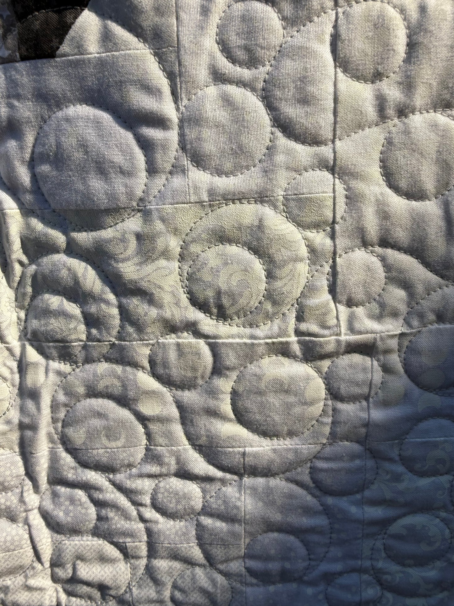 "Handmade quilt with traditional piecing and professional quilting finish"
