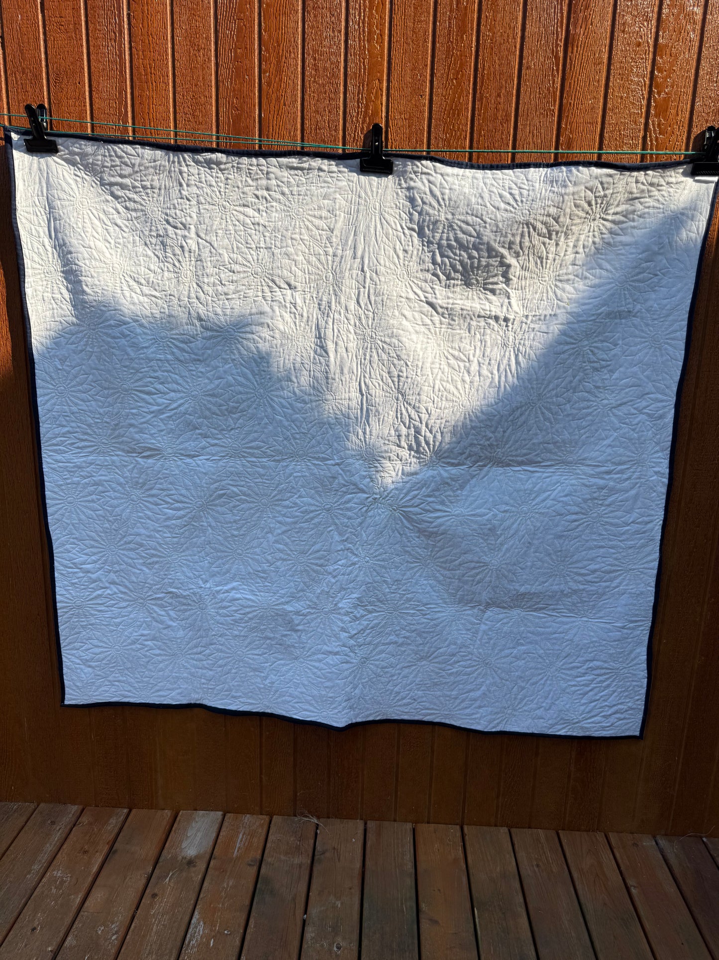 "Handmade quilt with traditional piecing and professional quilting finish"