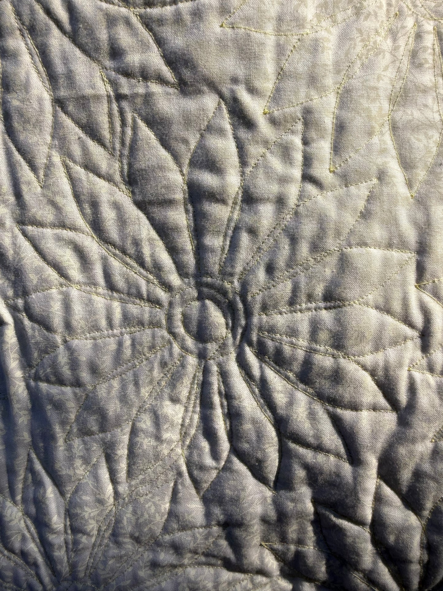 "Handmade quilt with traditional piecing and professional quilting finish"