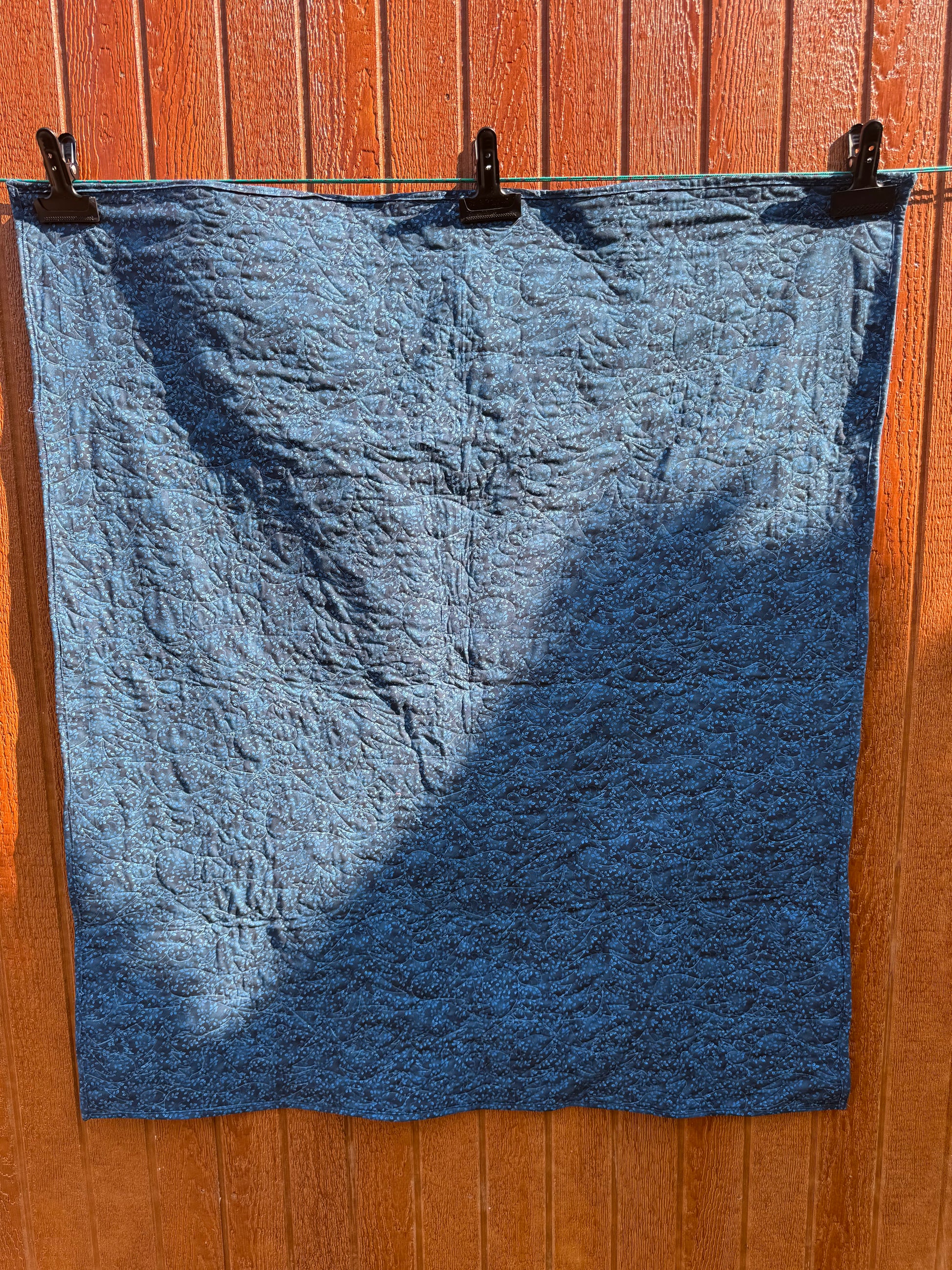 "Handmade quilt with traditional piecing and professional quilting finish"

