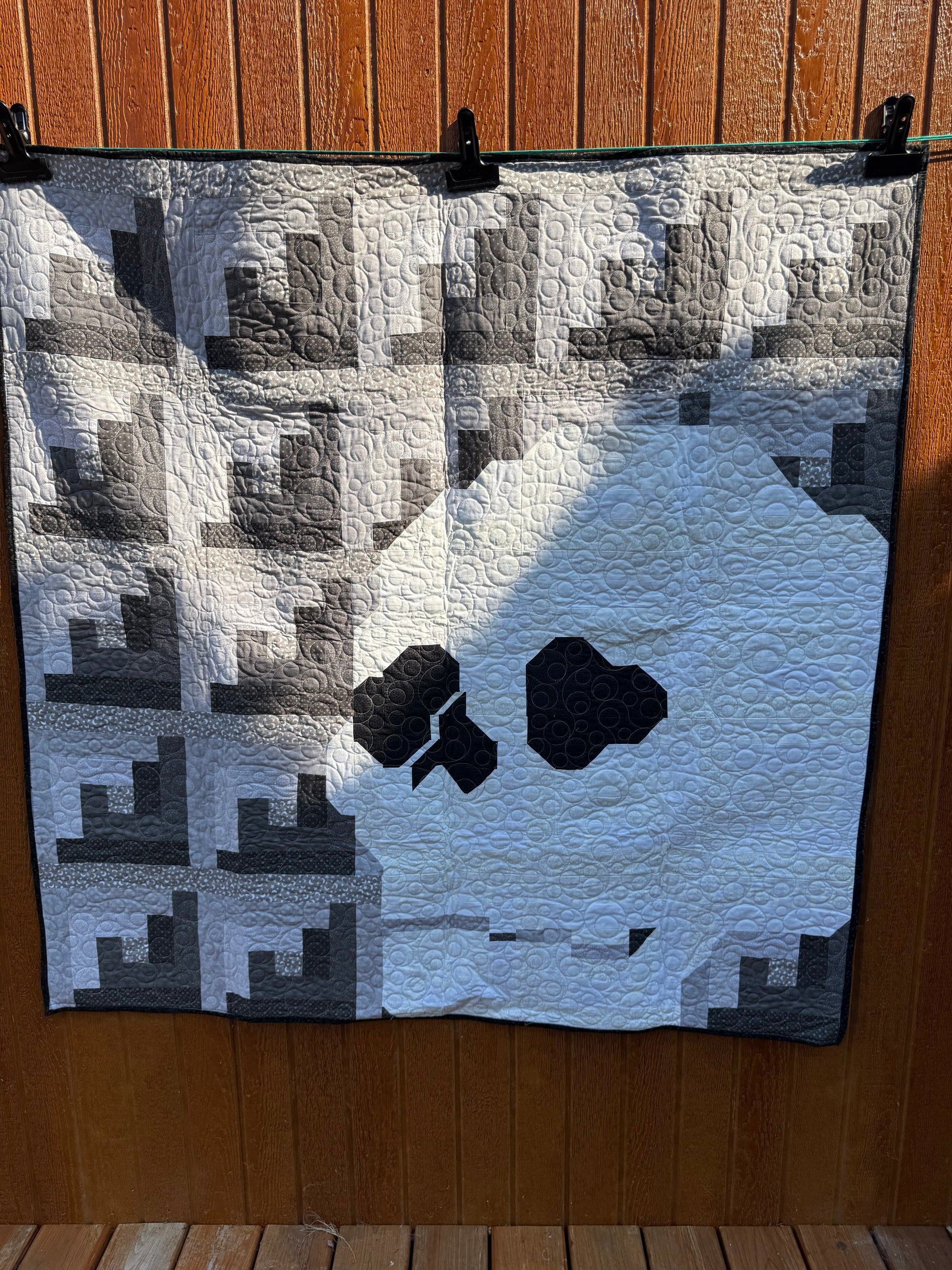 "Handmade quilt with traditional piecing and professional quilting finish"
