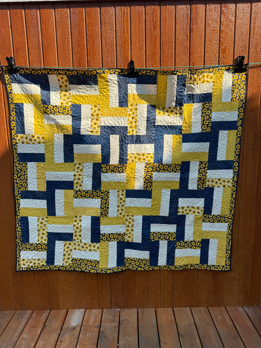 "Handmade quilt with traditional piecing and professional quilting finish"
