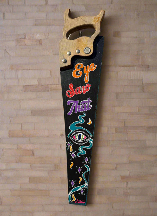 Decorative saw colorfully hand painted with the text ‘Eye Saw That’