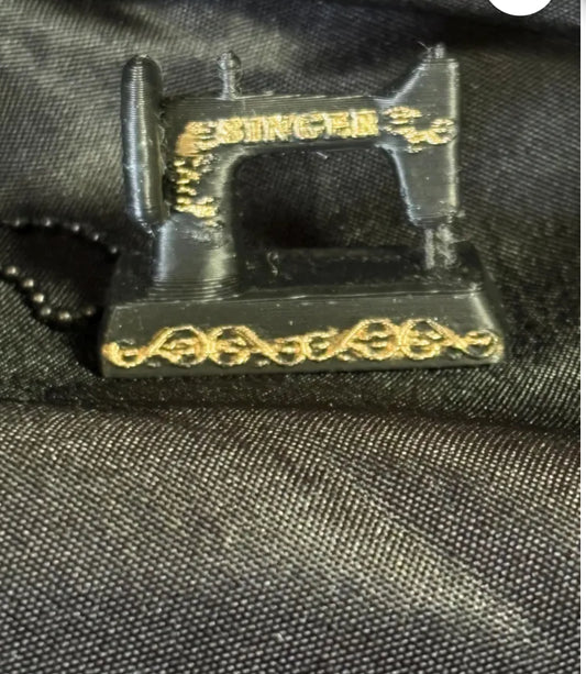 "Miniature sewing machine keychain accessory for quilters and sewing enthusiasts"
